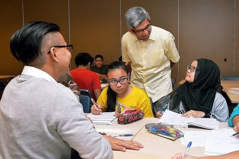 Dr Yaacob Ibrahim, Minister for Communications and Information and Mendaki chairman, with students in the Mendaki Intensive Revision Clinic at Jurong Spring Community Club, in the run-up to the N and O levels.