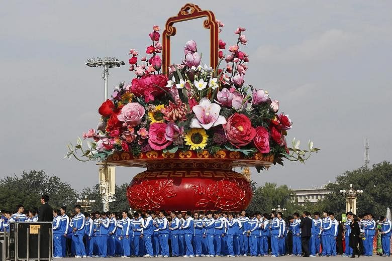 A giant floral arrangement on display at Tiananmen Square during a flower-laying ceremony yesterday at the Monument to the People's Heroes in Beijing. China's Golden Week of National Day holiday begins today.