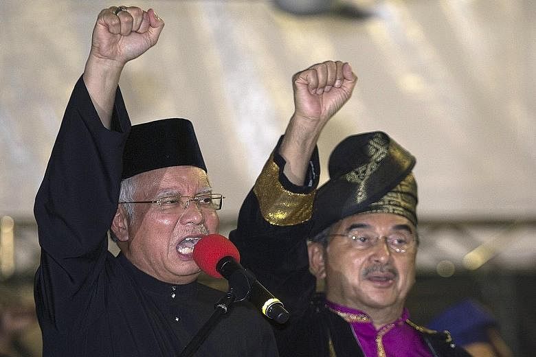 Malaysian Prime Minister Najib Razak (left) and National Silat Federation (Pesaka) president Ali Rustam shouting slogans during a Pesaka assembly in Kuala Lumpur last month.
