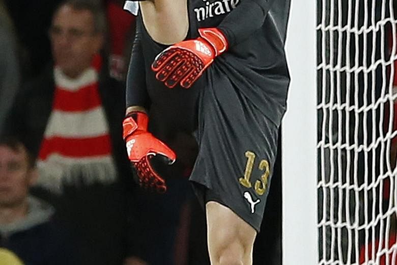 Arsenal goalkeeper David Ospina looking dejected after scoring an own goal to give Olympiakos a 2-1 lead. After two losses, the Gunners have an uphill task to make the round of 16.