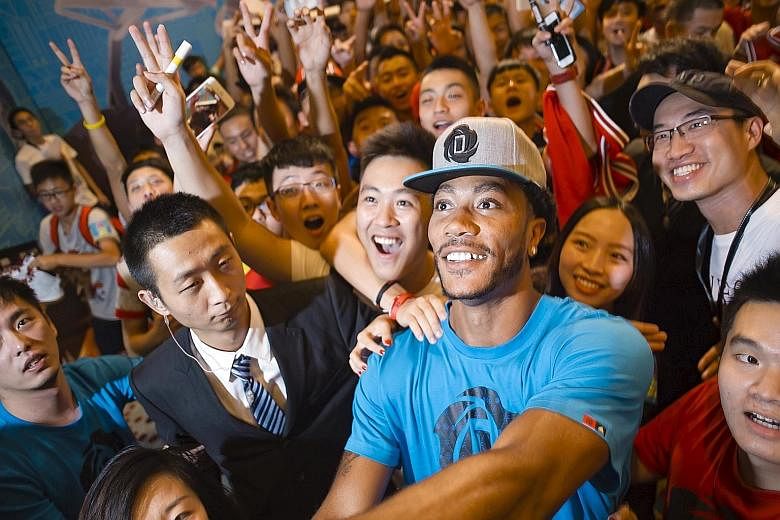The Chicago Bulls' Derrick Rose posing for a wefie with Chinese fans during a publicity event in Guangzhou in August. His NBA team have not put a date on the injury-prone guard's return.