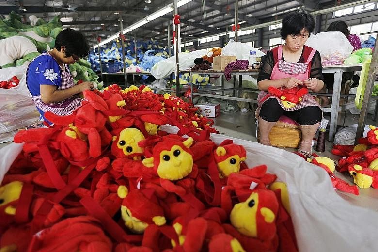 Chinese workers putting the finishing touches on toys in a factory before packing them for export. The Chinese slowdown caused WTO to cut this year's forecast for growth in Asian imports and exports.