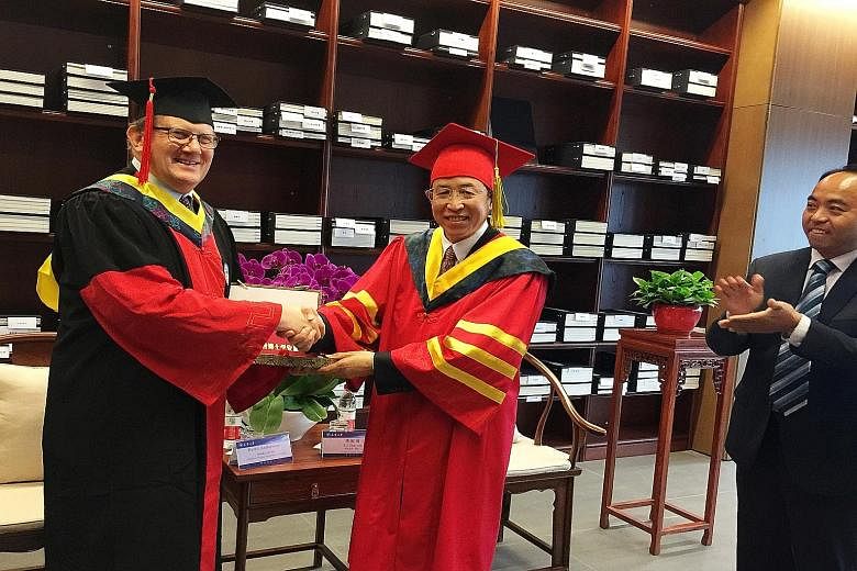 NTU president Bertil Andersson receiving his honorary doctoral degree from Tianjin University President Li Jiajun yesterday in recognition of his contributions in academia and forging international partnerships.