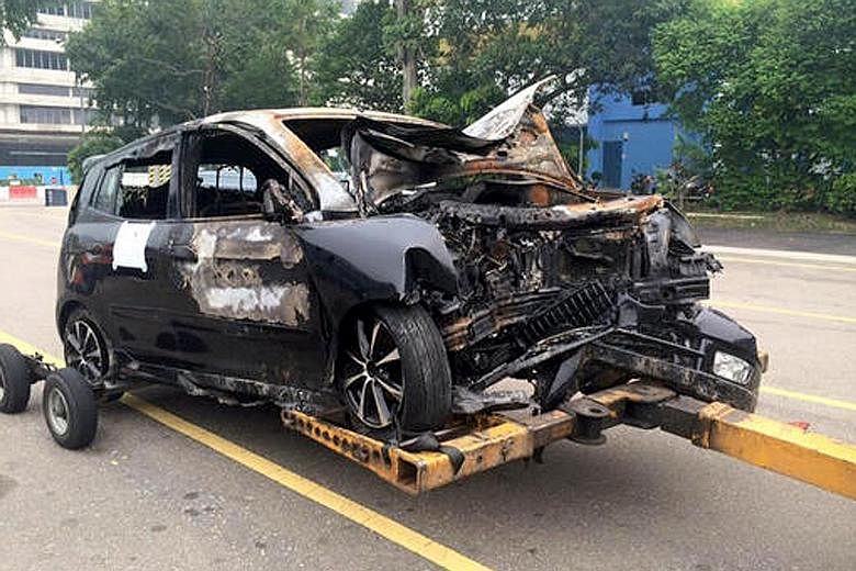 Cabby Weng Dianlai (left) rushed to the aid of Mr Raymond Ang, whose car (above) had crashed into a tree in Marymount Road and burst into flames on Sept 24.