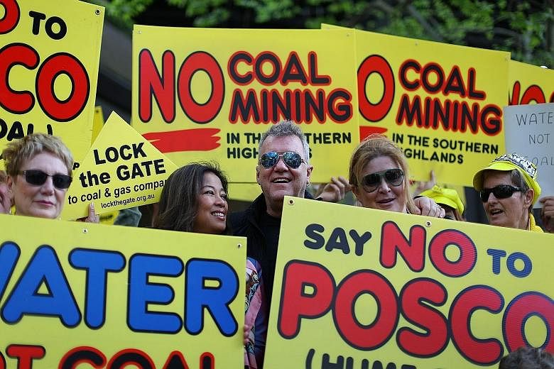 Rock singer Jimmy Barnes (centre) and Southern Highlands residents protesting in Sydney yesterday against a proposed coal mine in Sutton Forest. Canberra plans to make it harder for green groups to launch legal challenges.