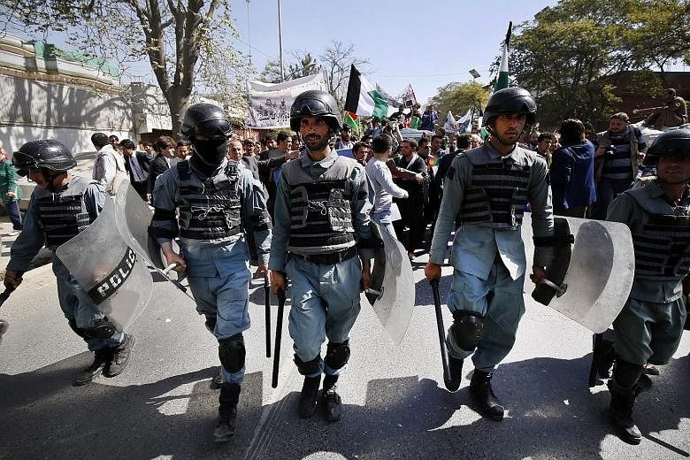 Members of the Afghan security forces at an anti-Taleban protest in Kabul, Afghanistan, yesterday. According to a ministry statement, 150 Taleban had been killed and 90 wounded in the overnight offensive to retake the city of Kunduz.