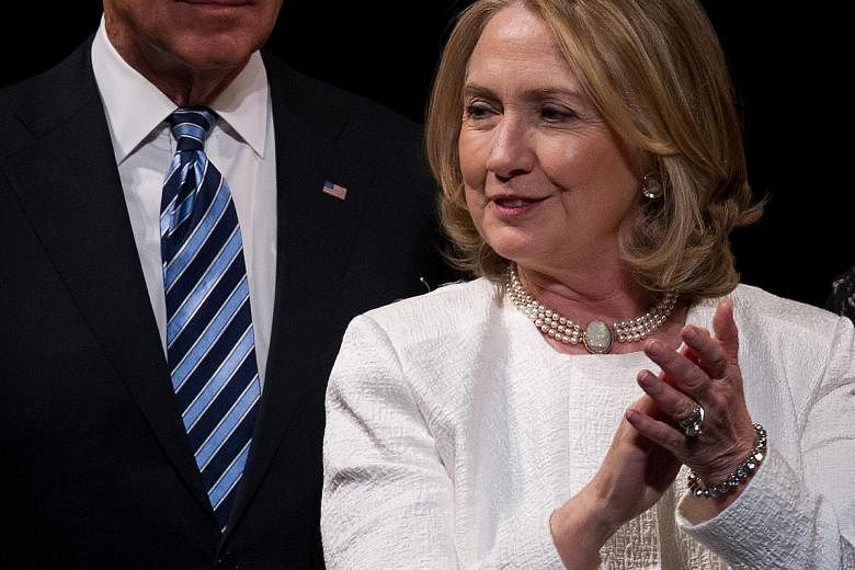 Mrs Hillary Clinton and Mr Joe Biden at an event in 2013 in Washington. Mrs Clinton's campaign is viewing the Vice-President's entry into the presidential race as a serious possibility.