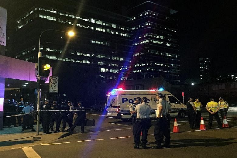 Police securing the area after the shooting incident that left two dead in Parramatta, a suburb in the metropolitan area of Sydney yesterday.