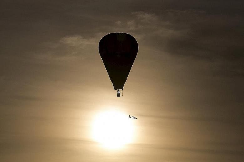 A hot air balloon in flight. If temperatures exceed the 2 deg C target, scientists say, the effects of climate change will become more intense.