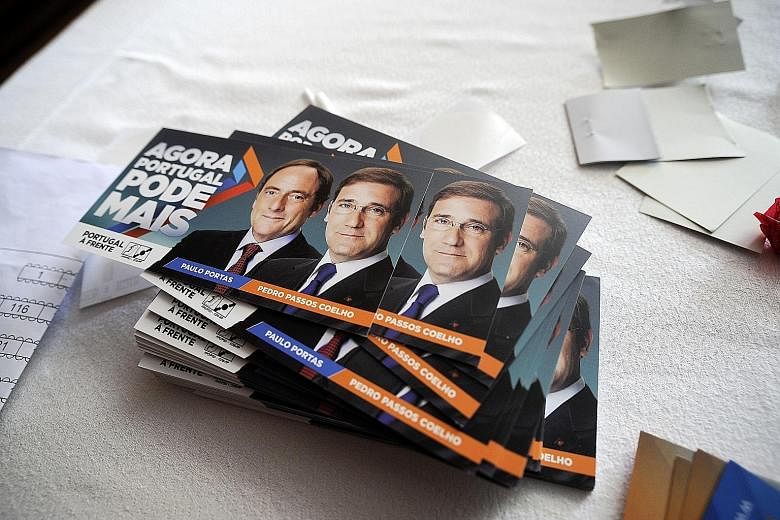 Campaign fliers for Portuguese Prime Minister Passos Coelho's ruling coalition. Tomorrow's elections are likely to go down to the wire.