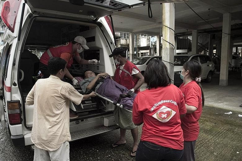 Volunteers from Noble Heart, a local NGO providing free ambulance services, transporting a patient from a hospital to his home in Yangon.