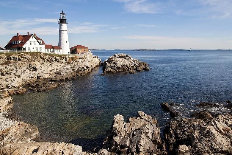 The riot of autumn colours (left) in Maine draws "leaf peepers", or people who travel there for the scenery. The historic Portland Head Lighthouse (far left) at the jagged shores of Fort Williams Park, Cape Elizabeth. A house swaddled with vibrant ci
