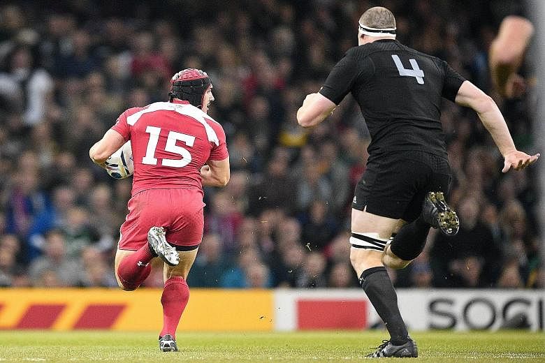 Georgia's full-back Beka Tsiklauri (left) can't be caught as he scores his team's first try against New Zealand. Georgia exposed some shortcomings in the defending champions and a win in their next game against Namibia will earn the Europeans a slot 