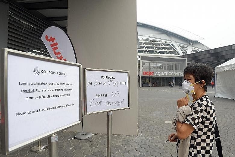 A disappointed fan looking at the signages of haze updates and the cancellation of the World Cup Day 1 finals at the OCBC Aquatic Centre. The organisers are hoping for better conditions today.