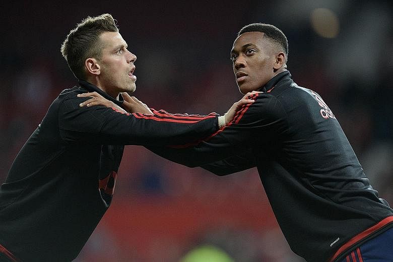 Manchester United's French teenage star Anthony Martial (right) warming up with team-mate and countryman Morgan Schneiderlin. While former United winger Lee Sharpe is not enthralled with Louis van Gaal's tactics, he feels the 19-year-old Martial is a