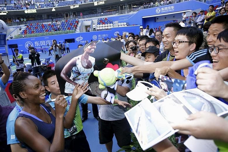 US veteran Venus Williams obliging fans after beating Garbine Muguruza when the Spaniard retired in the Wuhan Open final. Both players have reason to smile as they will enter the top eight spots in the WTA Finals Road to Singapore leaderboard.