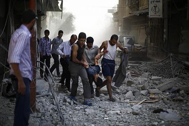 Syrians evacuating a wounded man following air strikes by Syrian government forces on the rebel-held town of Douma, east of the Syrian capital Damascus, last Friday.