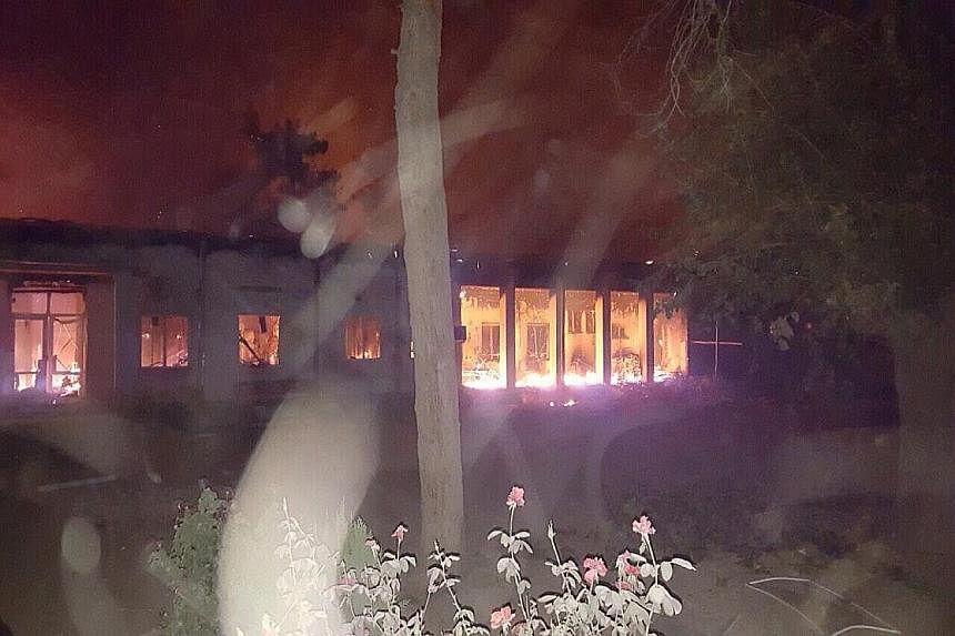 The MSF-run hospital in Kunduz ablaze after being hit in an air strike.