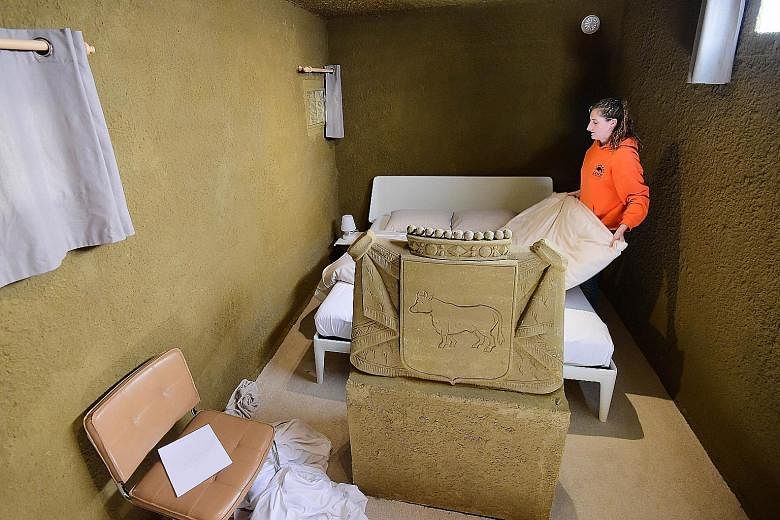An employee preparing the bedroom at the world's first "sandcastle hotel", constructed from tonnes of sand and reinforced with wood, in the small Dutch city of Osson October 2, 2015.