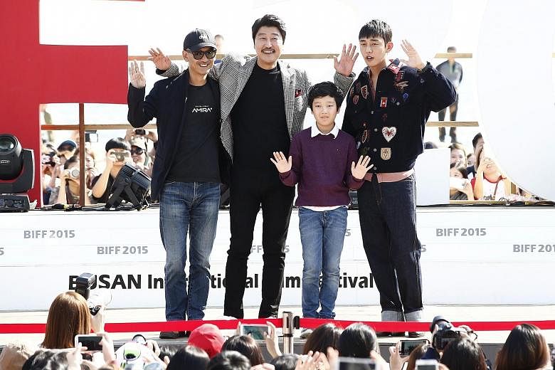 South Korean director Lee Joon Ik (far left, above) posing with actor Song Kang Ho, child actor Lee Hyo Je and actor Yoo Ah In at last Saturday's meet-and-greet for his movie The Throne at the Busan film festival. The period drama is South Korea's fo