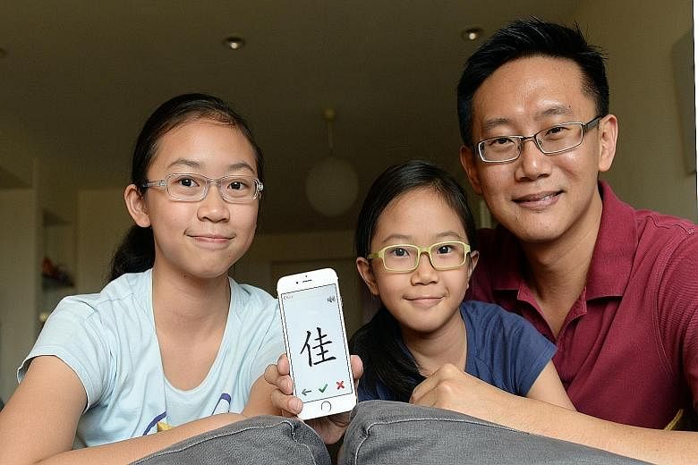 Software developer Daniel Chong, seen here with daughters Trenice, 12, and Alexis, nine, paid a native speaker $430 to record the audio tracks on his apps.