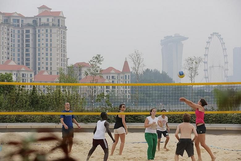 People enjoying the outdoors yesterday amid clearer skies. As of 6pm, the 24-hour Pollutant Standards Index (PSI) had fallen to between 81 and 98, in the high section of the moderate range. Today, the air quality is expected to be in the high end of 