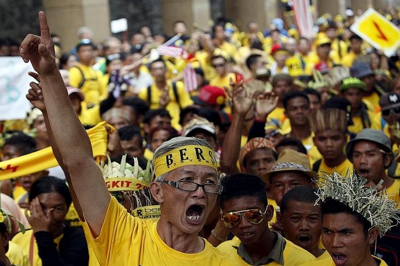 A Bersih supporter leading a group of Orang Asli - indigenous people - to Dataran Merdeka in Kuala Lumpur on Aug 30. Despite a sprinkling of other races, the anti-government demonstrations were predominantly Chinese affairs. PAS, which had joined pre