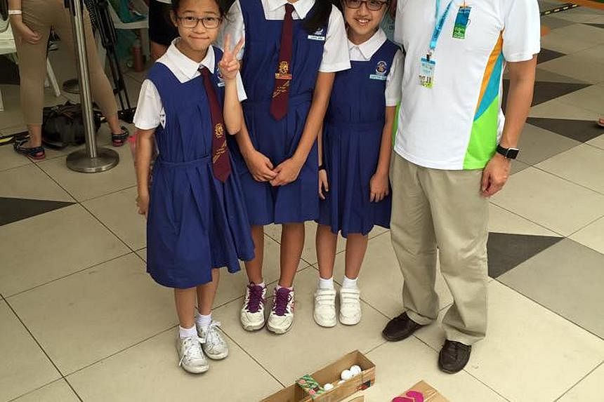 (Above) Mr Ng Chee Meng visiting a class during a Chinese lesson at Bukit View Primary School last Friday. (Right) Mr Ong Ye Kung with pupils from CHIJ Our Lady Queen of Peace at the launch of Clean and Green Week in Bukit Panjang last Saturday.