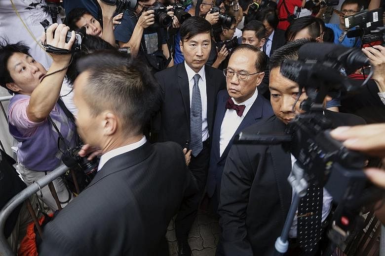 Donald Tsang, in his trademark bow tie, leaving the court in Hong Kong yesterday. His tenure as chief executive had invited criticisms of collusion between government officials and tycoons.