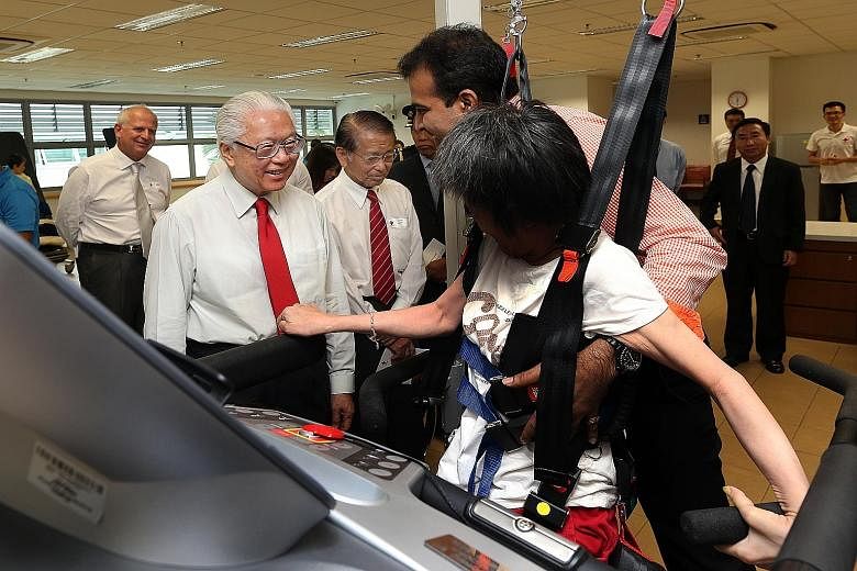 (From left): President Tony Tan Keng Yam, patron of the Singapore Red Cross, and Mr Tee Tua Ba, its chairman, at the Red Cross Home for the Disabled in Lengkok Bahru yesterday.
