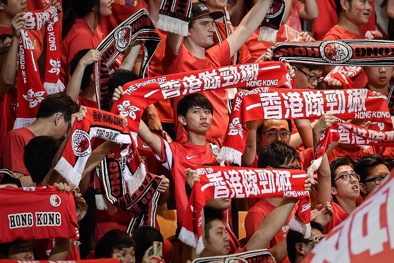 Football fans at the match between Hong Kong and Qatar last month. At the match, a carton of lemon tea was thrown at a Qatari player.
