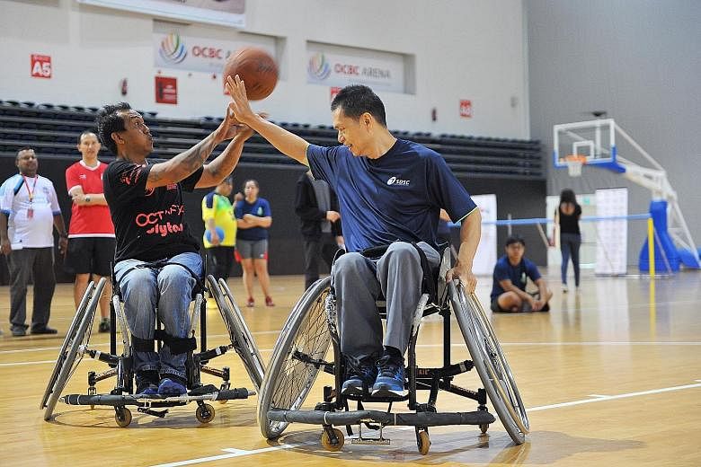Above: Nazarudin, 37, goalball athlete, making a save. Left: Kamas Mohd and Chua Chong Hoi tussling in a wheelchair basketball demonstration event.