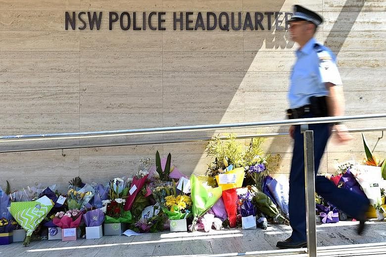 Flowers outside the New South Wales police HQ for employee Curtis Cheng, who was shot dead outside the building last Friday by a teen gunman.