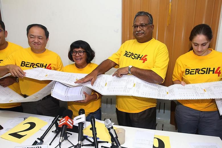Bersih officials showing the media a bank statement containing the account numbers of about 27,000 people who had put in money to help the electoral reforms group organise a rally in August. The officials said the list was being audited independently. 