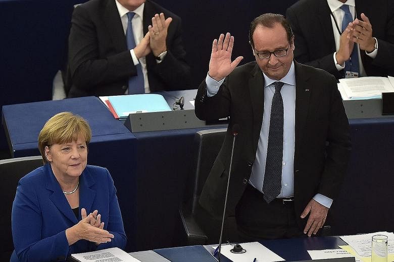German Chancellor Angela Merkel and French President Francois Hollande at the European Parliament in Strasbourg yesterday.