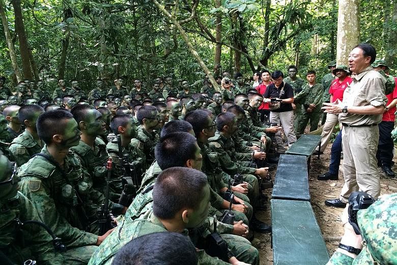 Deputy Prime Minister Teo Chee Hean meeting Singapore Armed Forces soldiers undergoing jungle training in Temburong, Brunei, yesterday. He was on a four-day visit that ended yesterday as part of the 3rd Young Leaders' Programme, jointly organised by 