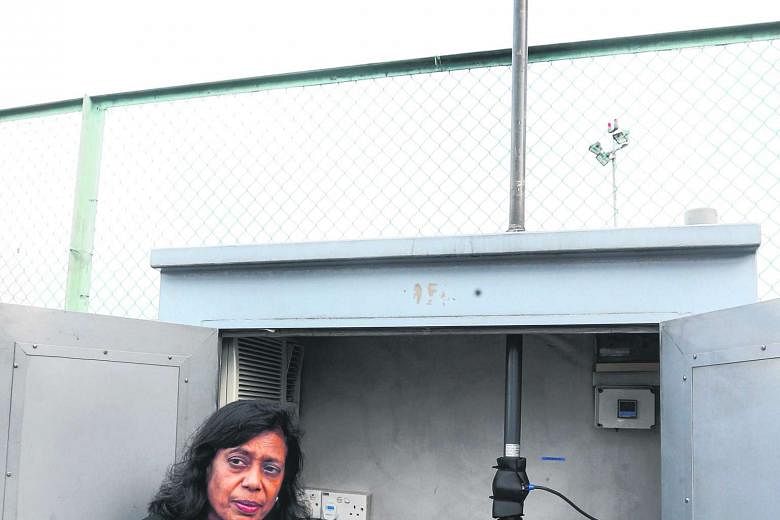 Mrs Indrani Rajaram with a machine used by NEA to help measure the concentration of PM2.5 in the air. Converting raw pollutant concentration data into one-hour PSI readings is not supported by health studies, she said.