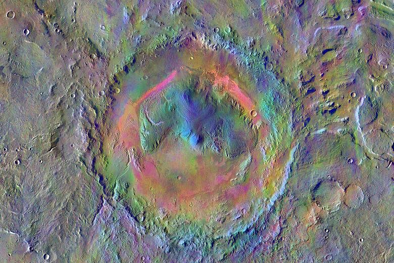 A mosaic image made using data from the thermal emission imaging system on Nasa's Mars Odyssey orbiter. Windblown dust appears pale pink and olivine-rich basalt looks purple. Dark, narrow, 100m-long streaks (above) called recurring slope lineae flowi
