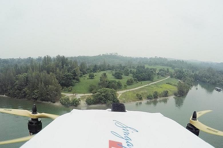 View from the SingPost drone during its successful delivery trial on Sept 25. It flew 2km, between Lorong Halus and Pulau Ubin, carrying a letter and T-shirt in a packet. The drone prototype has safety features designed for dense urban areas.