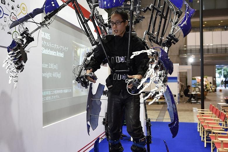 A man testing a Skeletonics robot suit that extends the movement of human arms and legs. Besides smart gadgets and appliances, robots were also key attractions at the show.