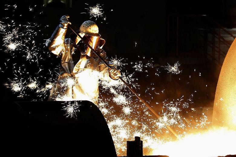 Sparking off the drop were a slowdown in China, Germany's third-biggest trade partner, as well as in other emerging markets that have been key destinations for German exports. At left is a worker in a steel factory in the western German city of Duisb