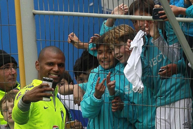 Brazil goalkeeper Jefferson takes a "wefie" with fans as the Selecao trained in Santiago before their crunch tie against Chile.