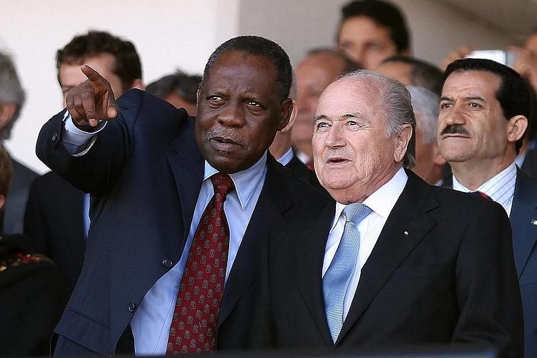 Cameroon's Issa Hayatou (left, in a 2012 picture) will now serve as the acting president of Fifa, replacing Sepp Blatter, who has been slapped with a 90-day ban by Fifa's Ethics Committee.