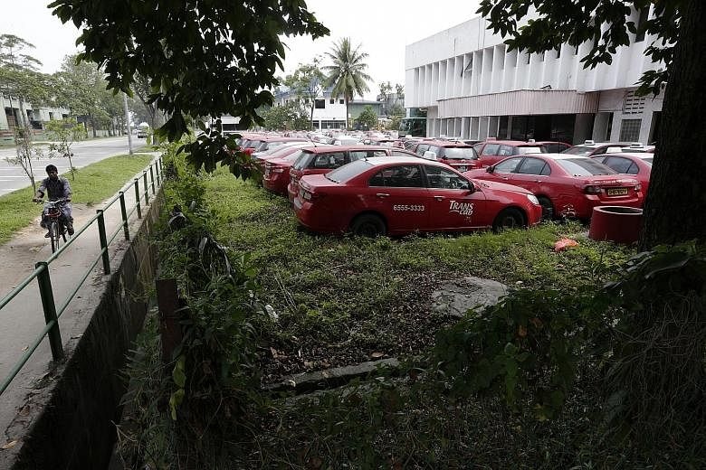 Trans-Cab taxis sitting idle in a yard in Sungei Kadut. An ST visit found as many as 800 of the operator's taxis parked in its yard, many covered in a layer of dust. Higher rental rates, stricter service norms and greater competition have prompted ma