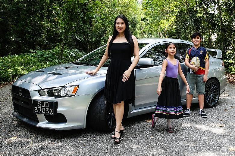 Ms Wendy Tan, assistant dean at the law faculty of the National University of Singapore, with her Mitsubishi Evo X, son Elijah and daughter Bethany.