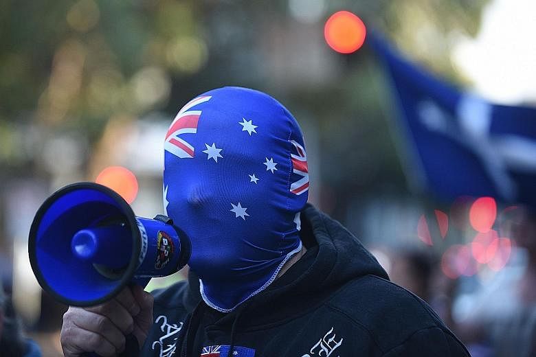 A protester outside the Parramatta mosque in Sydney yesterday. The demonstration forced parts of Parramatta to be closed. Since last week's shooting, anti-Islam fringe groups have called for the mosque that the 15-year-old gunman attended to be close