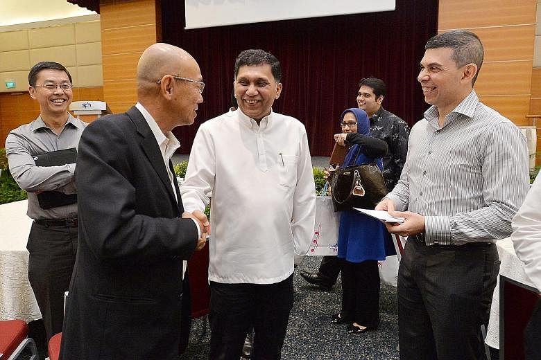 At The Straits Times School Pocket Money Fund Appreciation Day yesterday were (foreground, from left) ST editor-at-large Han Fook Kwang, donor Mohamed Abdul Jaleel and ST editor Warren Fernandez. Mr Han will be stepping down as the fund's chairman, w