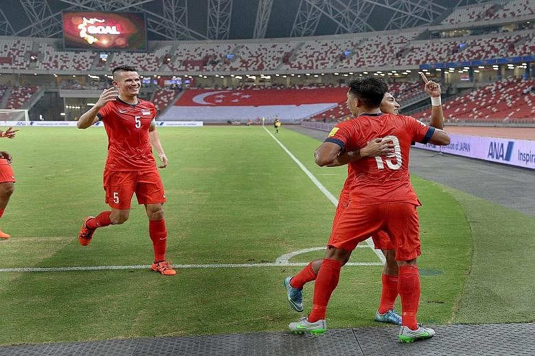 Khairul Amri (back to camera), celebrating his goal with Baihakki Khaizan (left) and Faris Ramli. It turned out to be Singapore's winner against Afghanistan in Thursday night's World Cup Asian Group E qualifier at the National Stadium, watched by 7,1