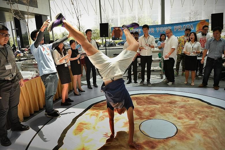 From K-pop to hip hop, workers in the Central Business District showed their dance moves for free roti prata on Thursday. The Dance For Your Prata lunchtime event took place at The Cube, a plaza linking the two towers of Asia Square in Marina Bay. It