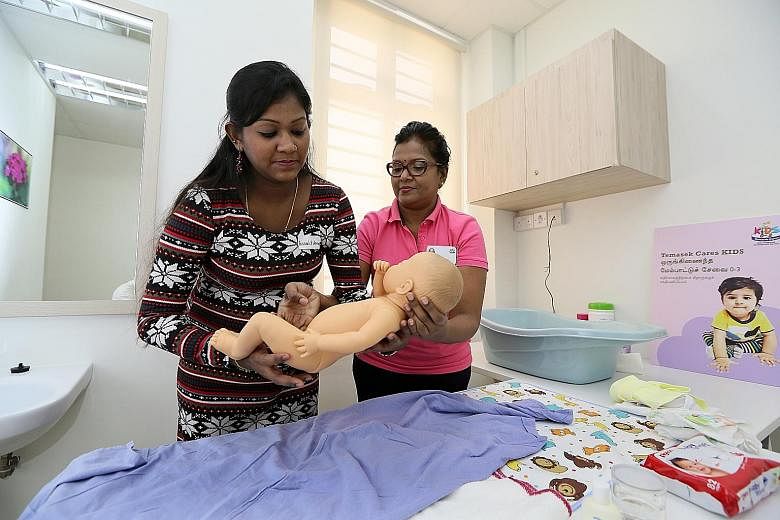Madam Annaletcumi Ravichandran (left) attending an infantcare class at the newly opened one-stop centre, which provides health, social and educational services to needy families with infants and toddlers.